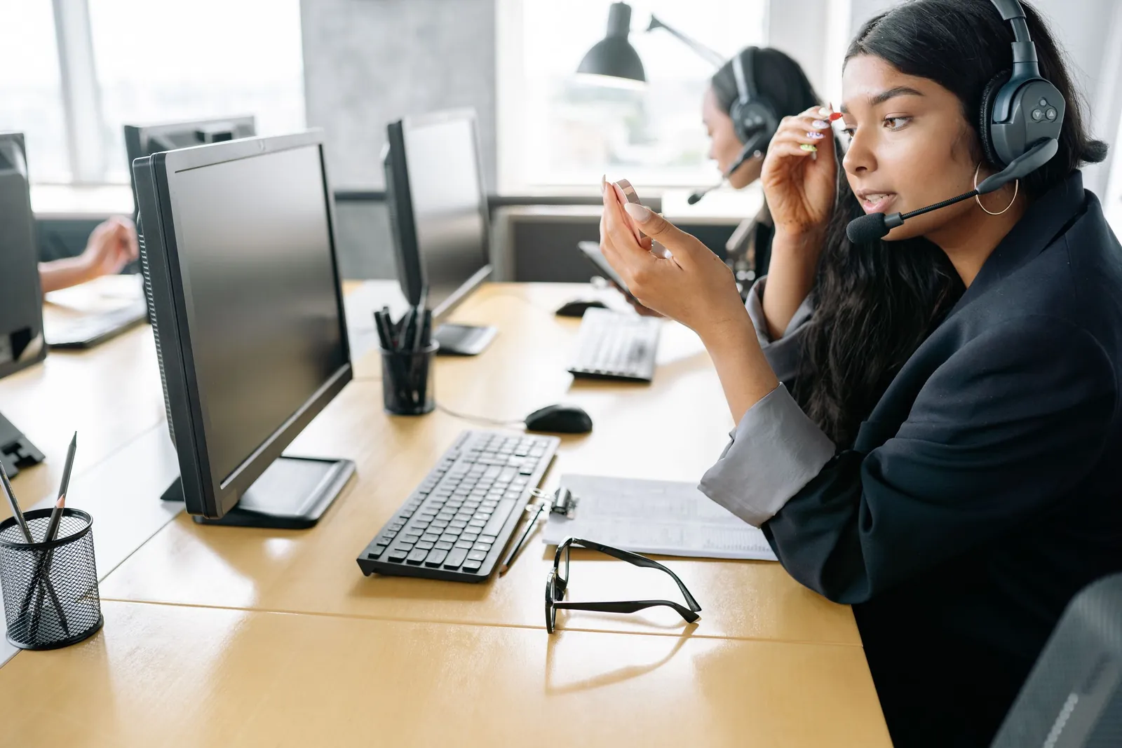 A support specialist on a call at her workstation
